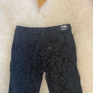 Levi mid-rise black jeans with velvet accents